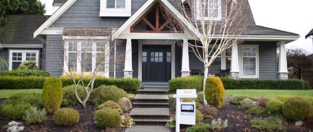craftsman style house with a for sale sign in front