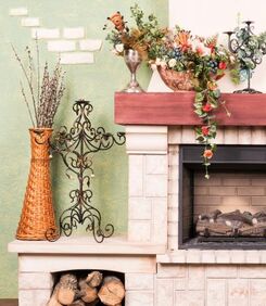 Fireplace with artificial flowers on the side and on the mantel
