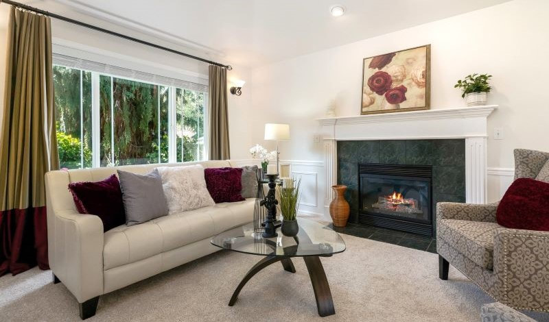 Beautifully decorated formal living room that showcases the fireplace, owner's furniture and rented furniture.