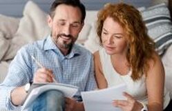 A couple making a list of their wants and needs for home search
